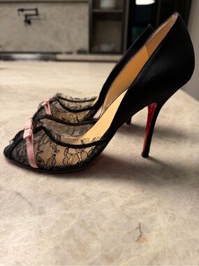 Gently worn Christian Louboutin Black Lace Pointed Toe Pumps with Pink Bow